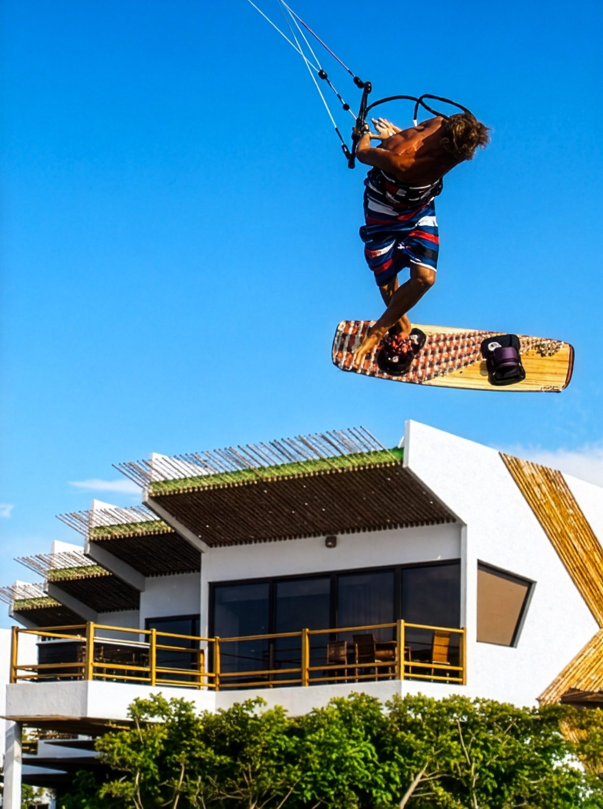 Kitesurfer soaring above the resort building